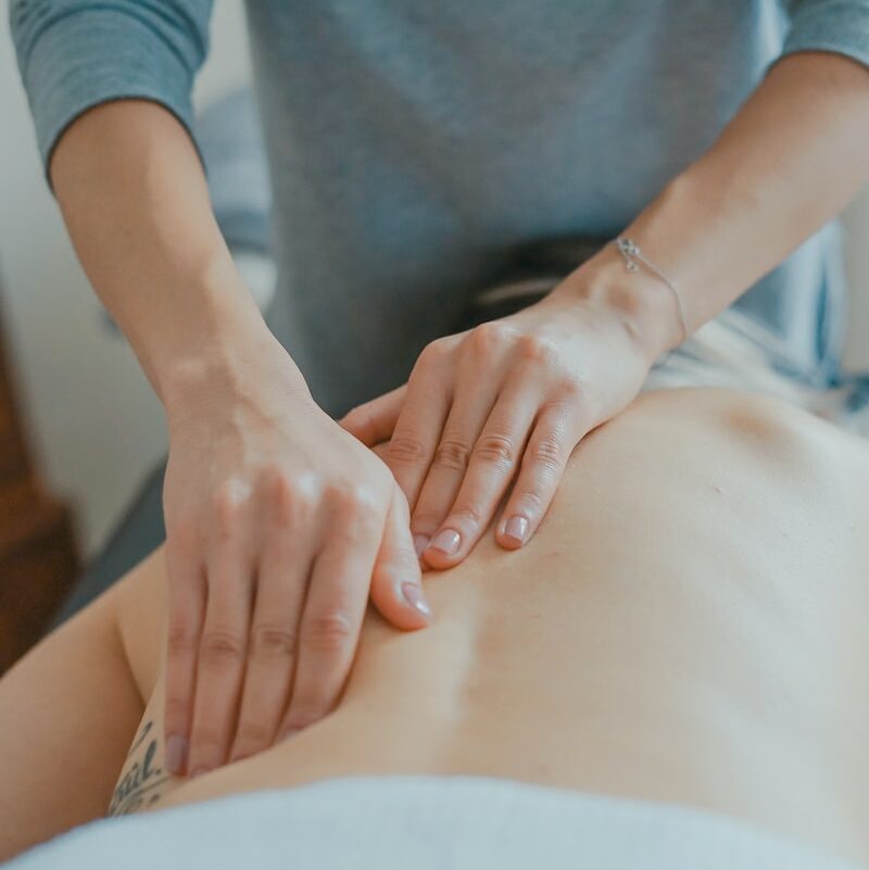 man massaging woman's body